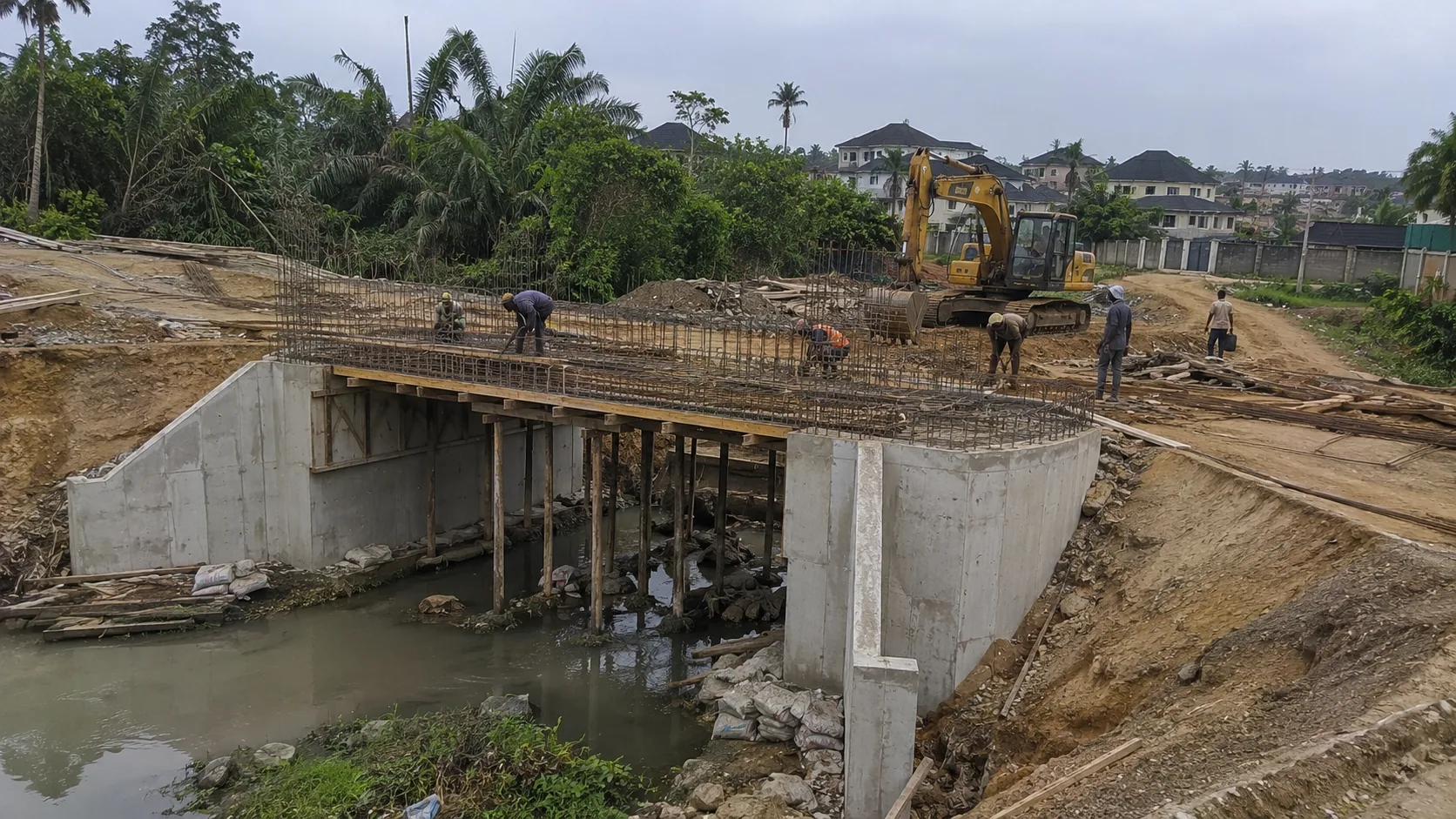 Reinforced concrete bridge or culvert structure under construction across a water channel