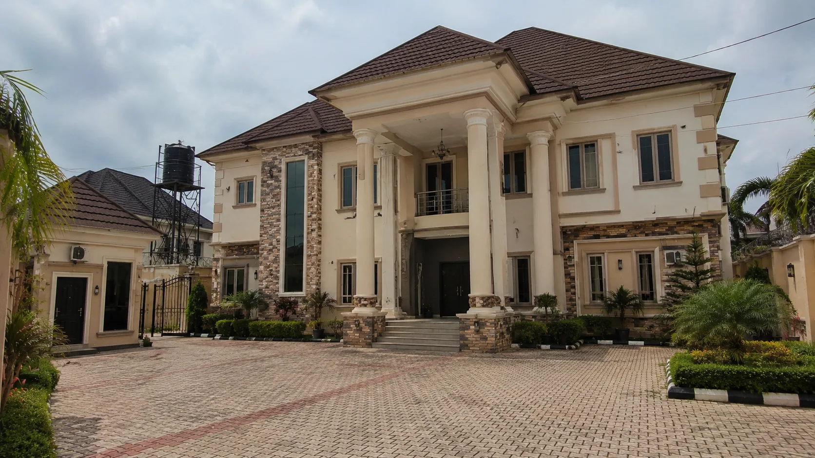 Completed classical-style residence with columns and stone accents